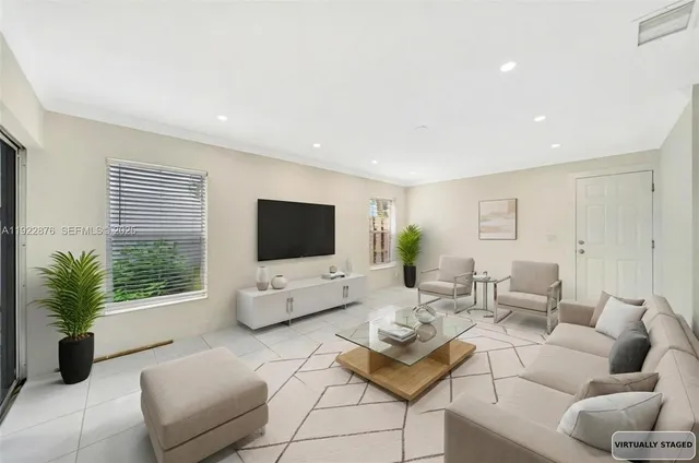 a living room with furniture a flat screen tv and a large window