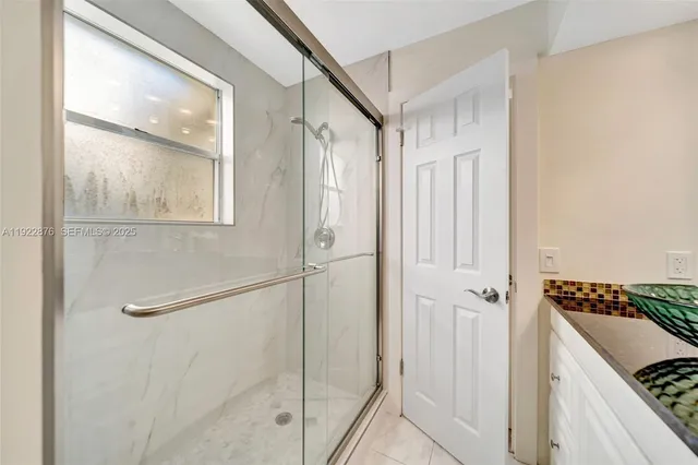 a bedroom with a bed and a potted plant