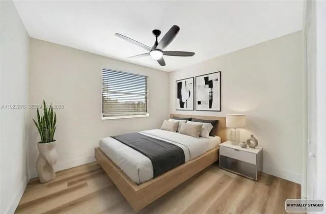 a spacious bedroom with a bed and a window