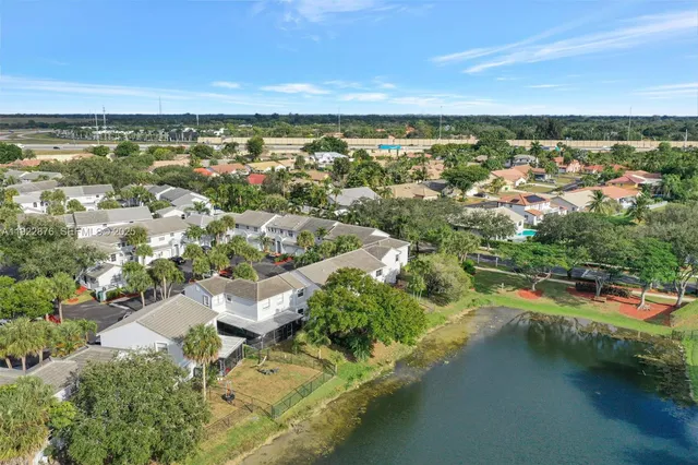 an aerial view of residential houses with outdoor space and river