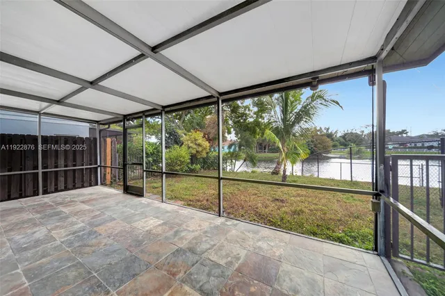 a balcony with furniture and a potted plant
