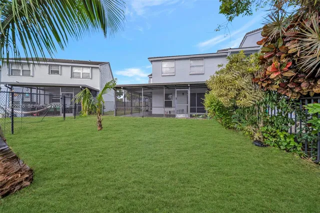 a front view of house with a garden