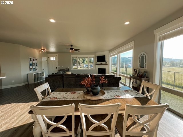946 South Calapooia Street Sutherlin, OR 97479 - Photo 5 of 31 a view of a dining room with furniture large windows and wooden floor