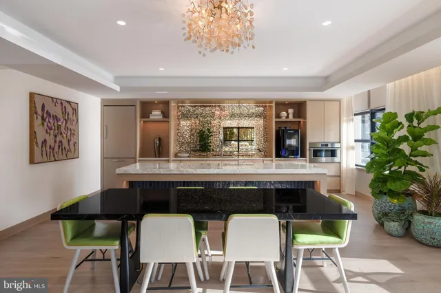 a dining table with chairs and window