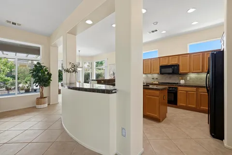 a kitchen with stainless steel appliances a refrigerator sink and stove