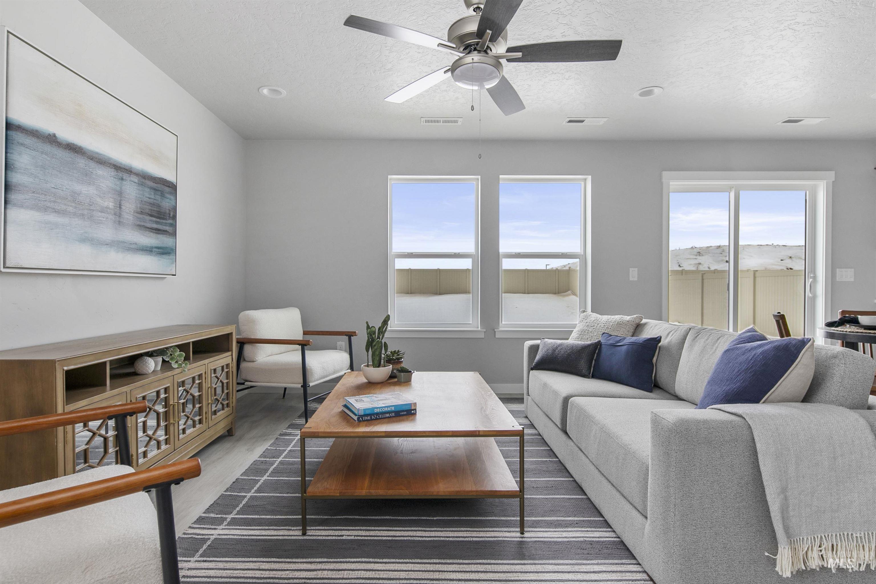 480 South Bobby Way Kuna, ID 83634 - Photo 3 of 9 Living area featuring a textured ceiling, wood finished floors, and a ceiling fan