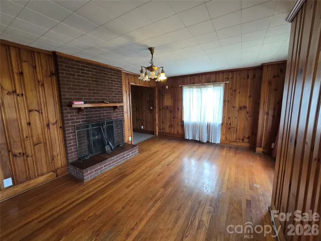 wooden floor in an empty room with a fireplace