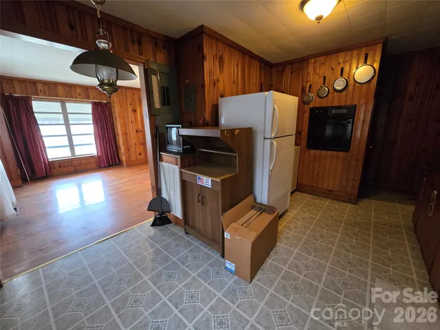 a view of kitchen with furniture and a refrigerator