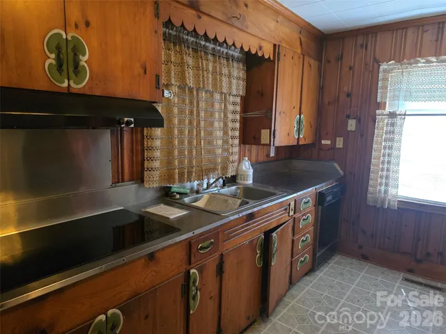 a kitchen with granite countertop a sink and a stove