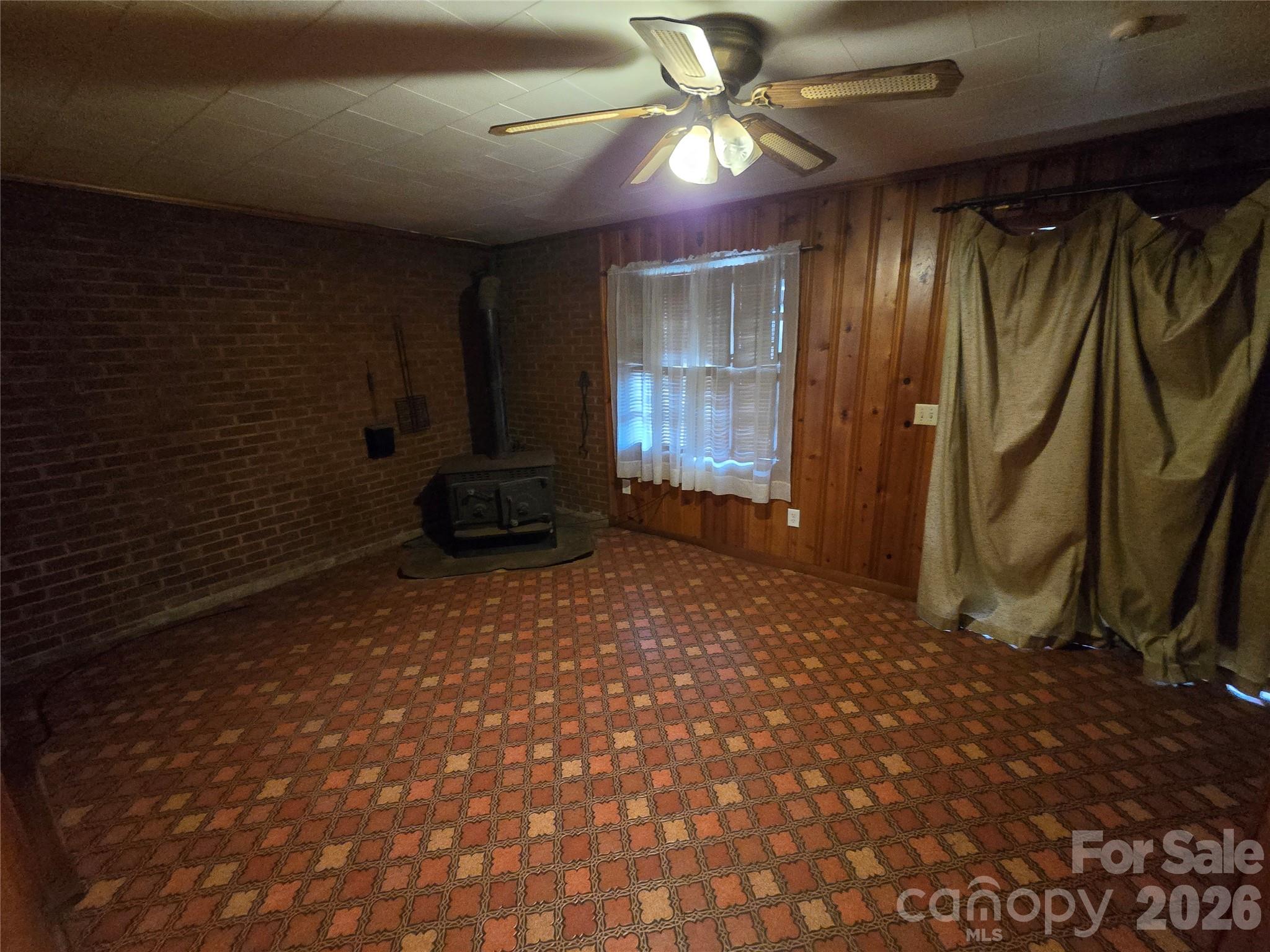 419 South Pearl Street Troy, NC 27371 - Photo 8 of 24 a big room with chandelier fan and windows
