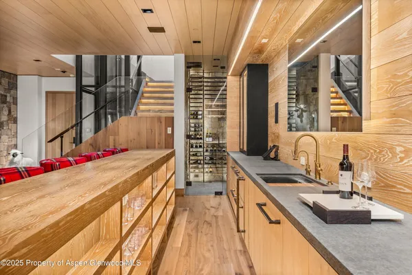 a view of a kitchen with a sink and wooden floor
