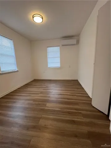 a view of room with wooden floor