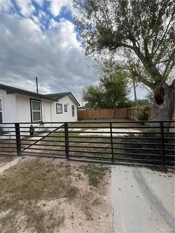 a view of house with stairs and wooden fence