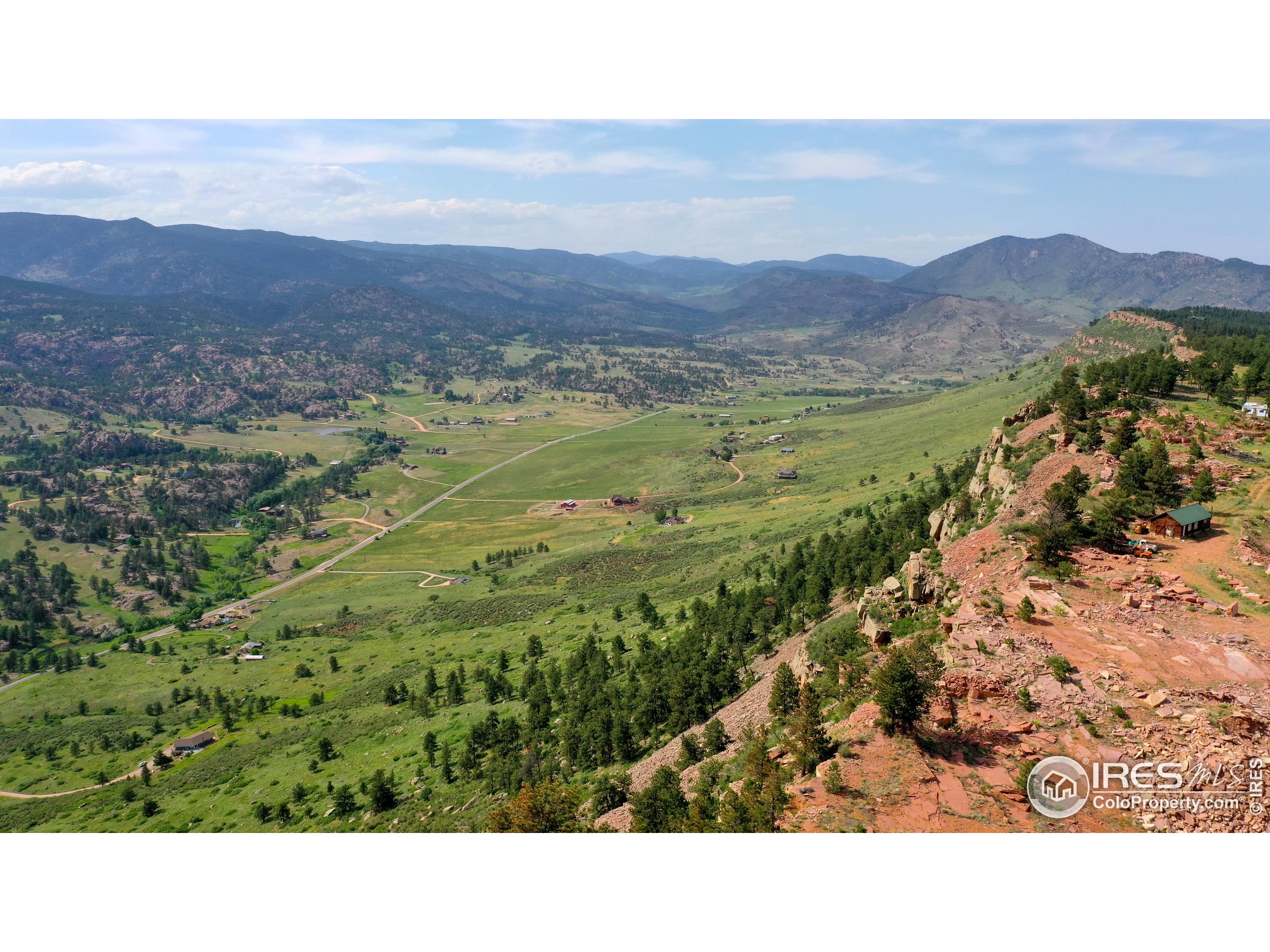 a open area with mountains in the background