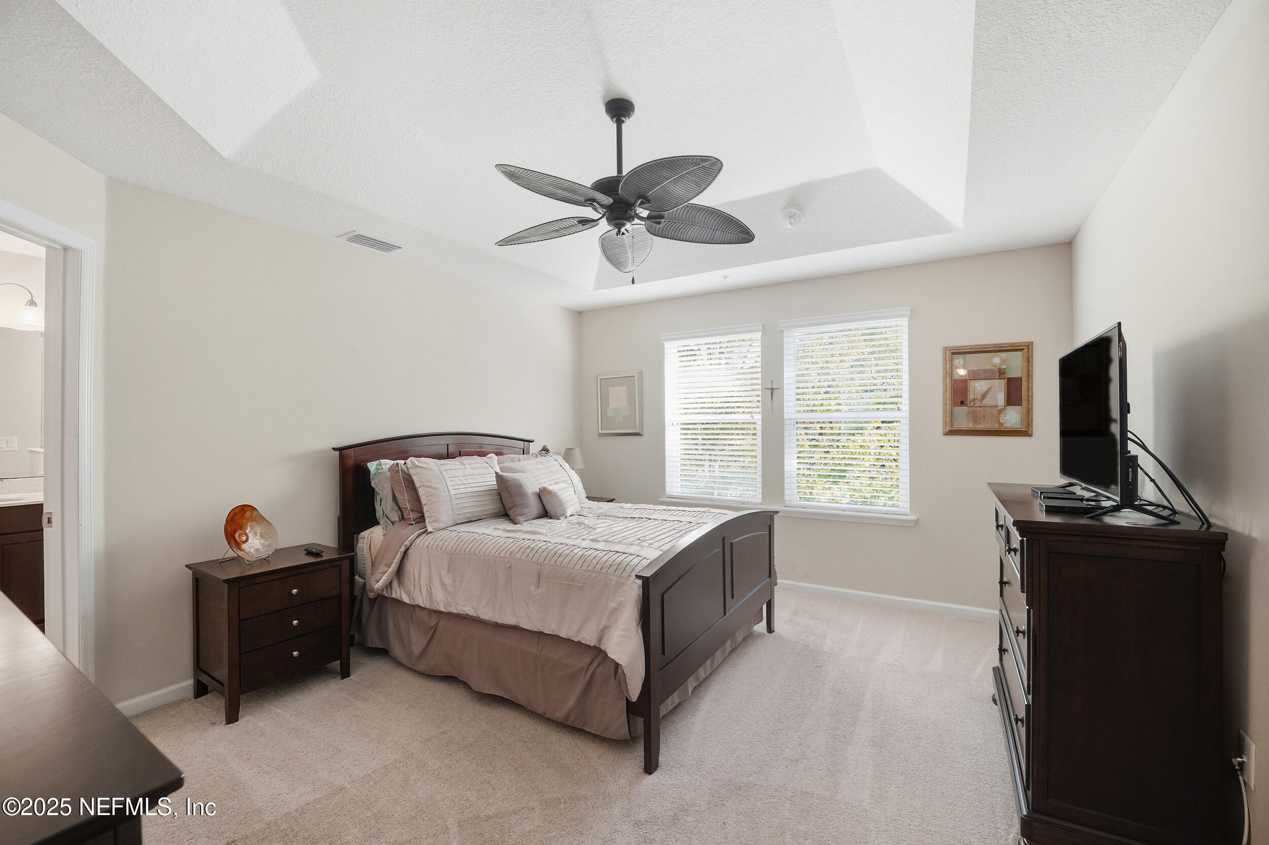 362 Paradas Place St. Augustine, FL 32092 - Photo 12 of 27 a bedroom with a bed and a flat tv screen on the dresser