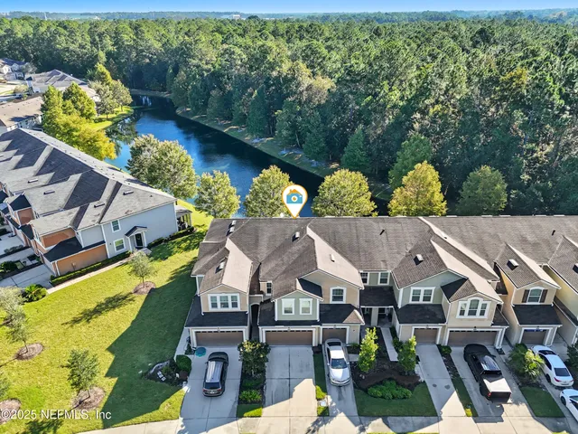 an aerial view of multiple houses with yard