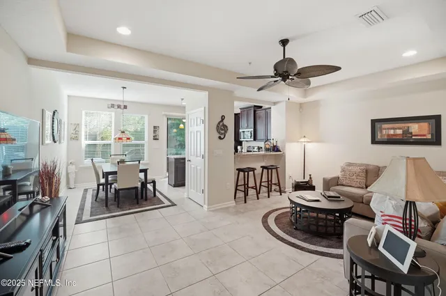 a living room with furniture a dining table and a fireplace