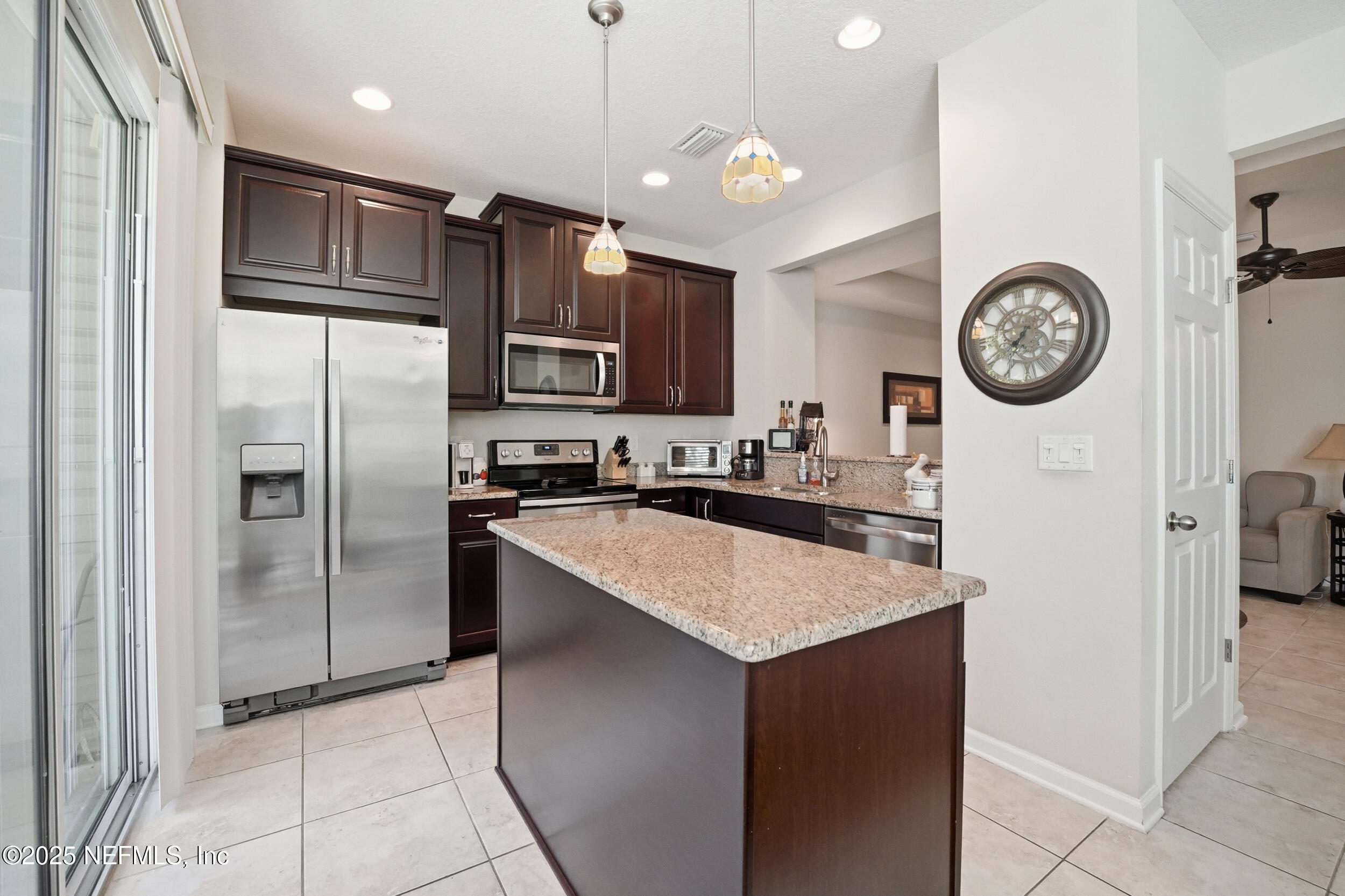 362 Paradas Place St. Augustine, FL 32092 - Photo 7 of 27 a kitchen with stainless steel appliances granite countertop a refrigerator a stove a sink and a refrigerator with wooden floor