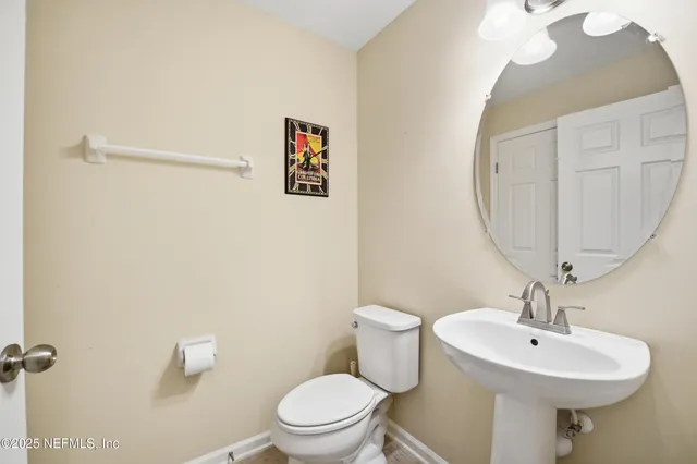 a bathroom with a sink a mirror and a toilet