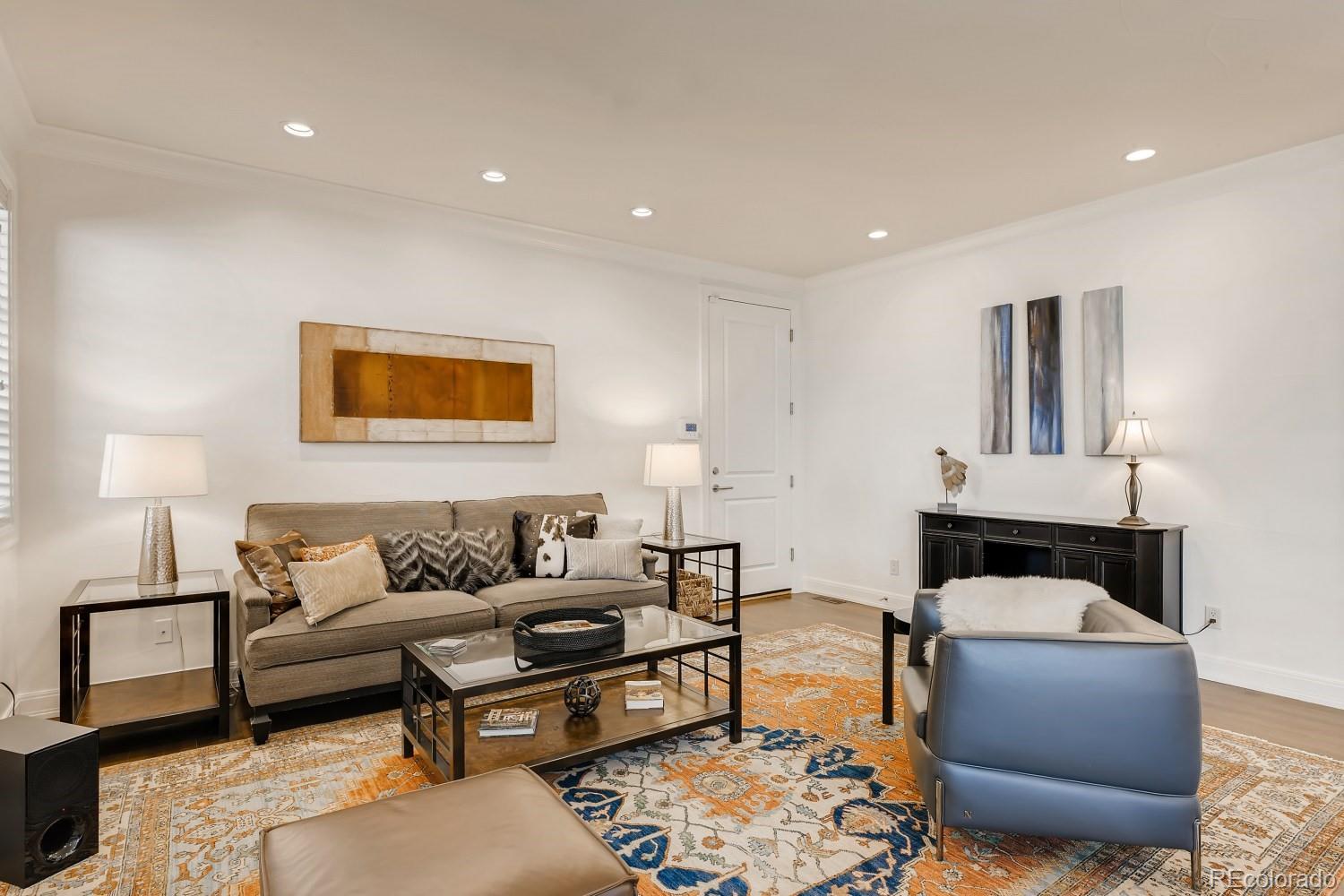 436 Jackson Street Denver, CO 80206 - Photo 11 of 40 a living room with furniture and a lamp
