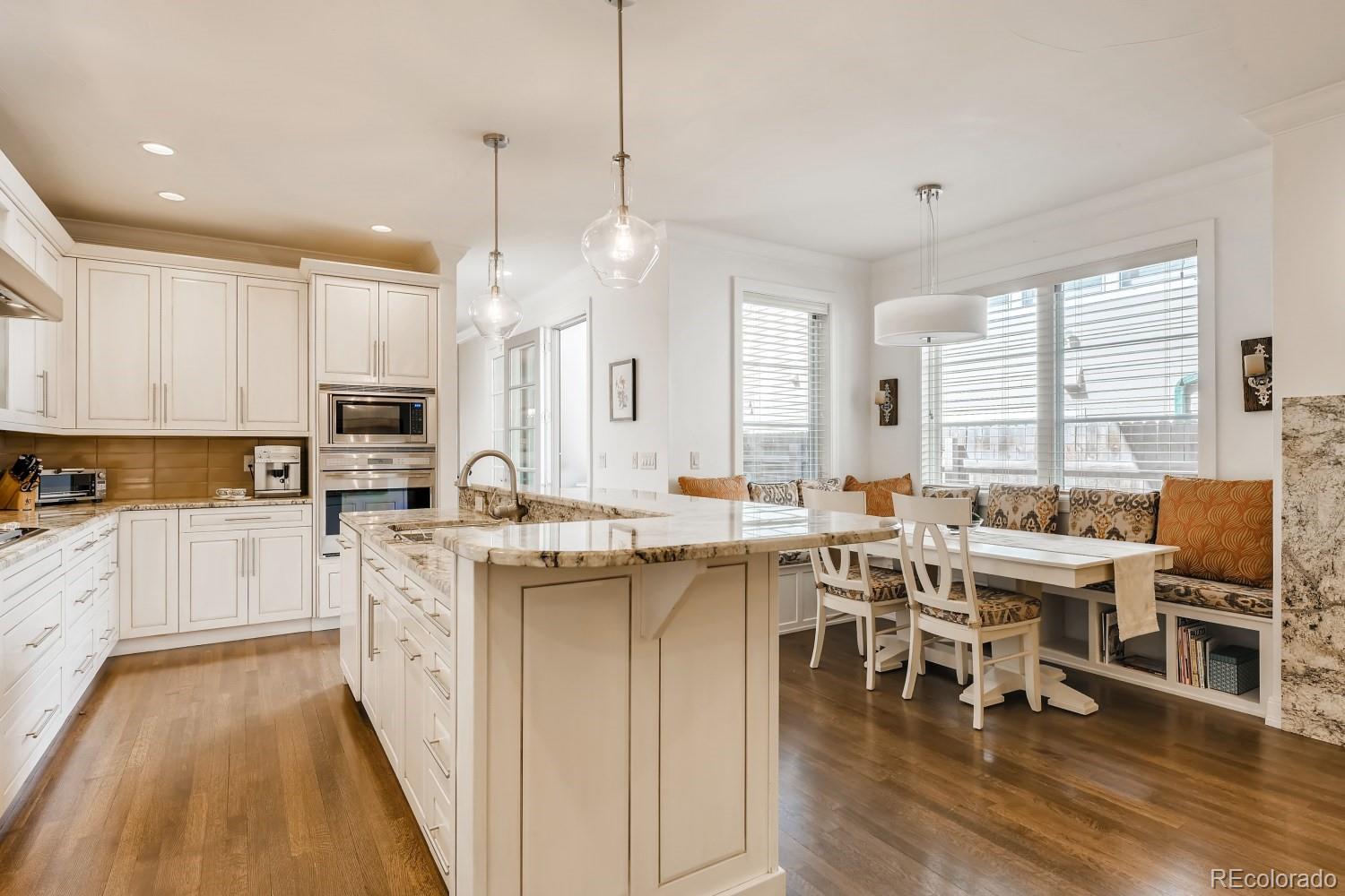 436 Jackson Street Denver, CO 80206 - Photo 15 of 40 a open dining room with stainless steel appliances granite countertop a stove and white cabinets