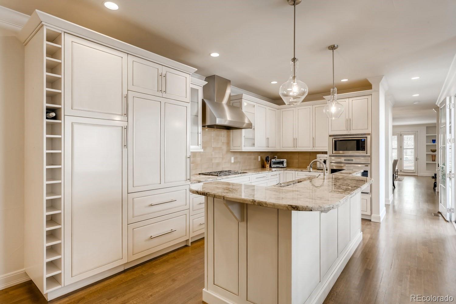 436 Jackson Street Denver, CO 80206 - Photo 17 of 40 a kitchen with kitchen island a white counter top space cabinets and a sink