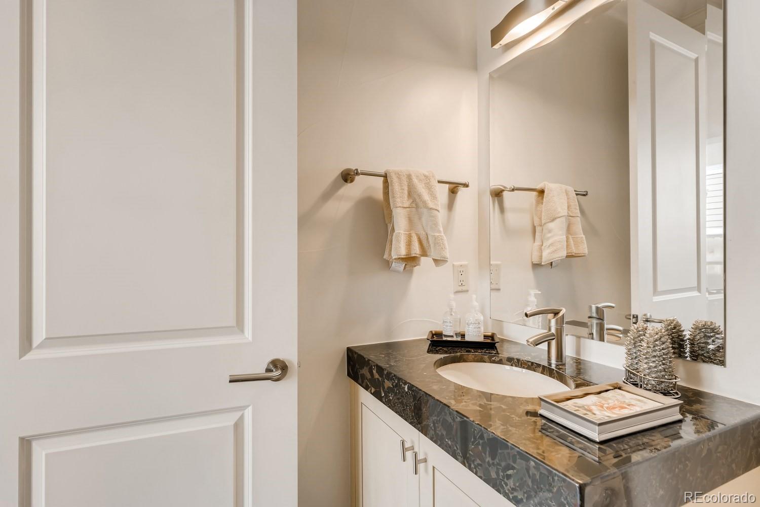 436 Jackson Street Denver, CO 80206 - Photo 18 of 40 a bathroom with a granite countertop sink and a mirror