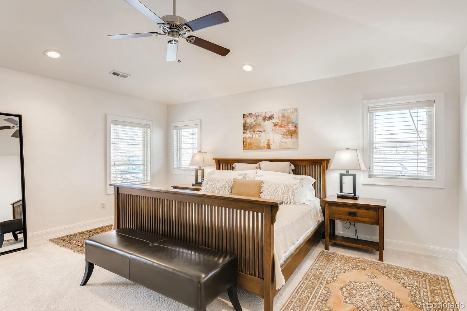 436 Jackson Street Denver, CO 80206 - Photo 20 of 40 a bedroom with a bed and a dresser next to a window