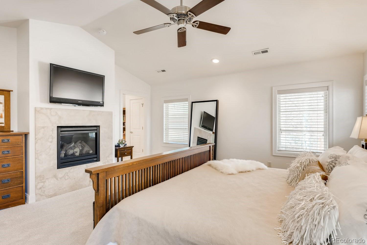 436 Jackson Street Denver, CO 80206 - Photo 21 of 40 a bedroom with a large bed and a fireplace