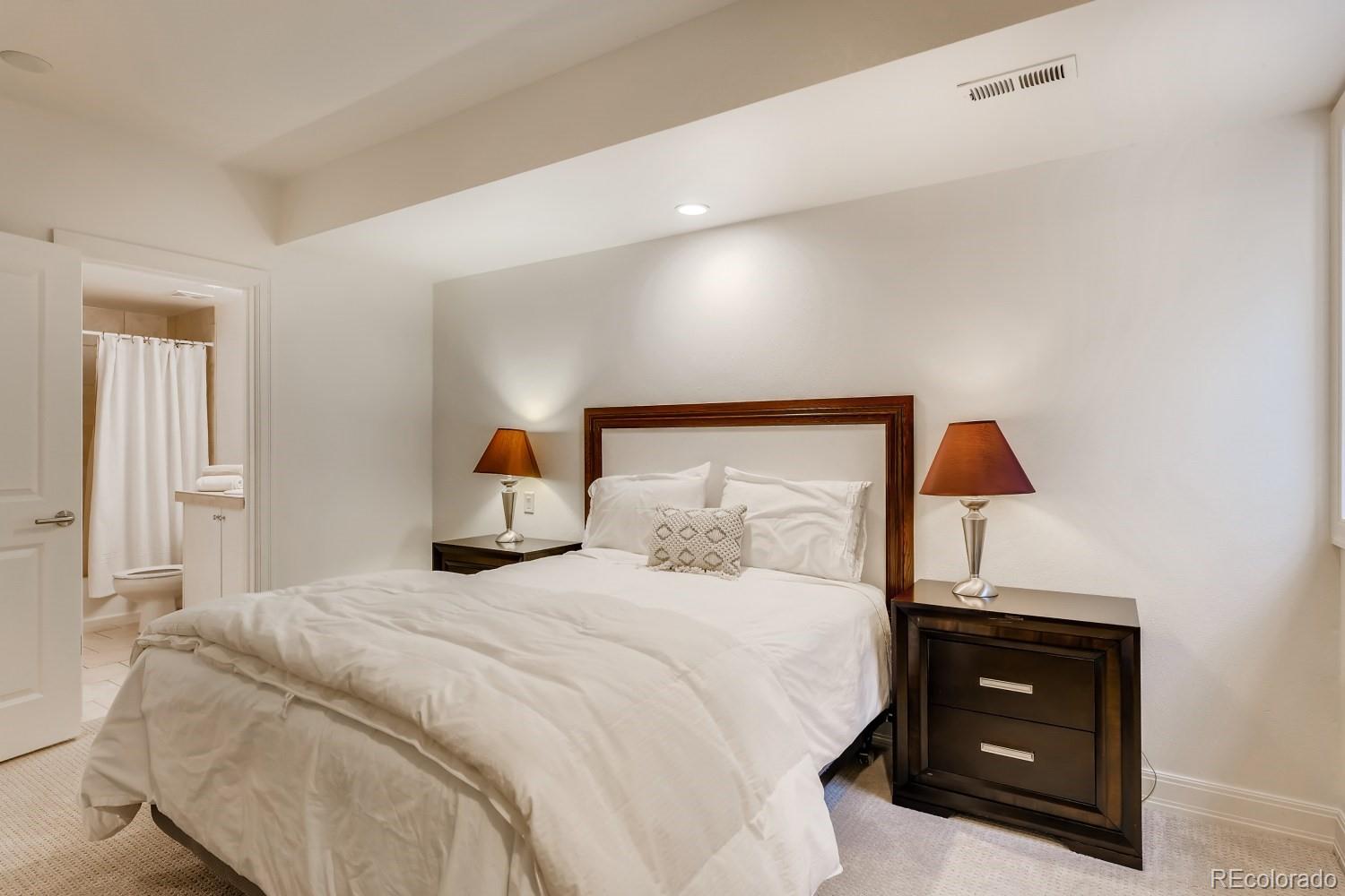 436 Jackson Street Denver, CO 80206 - Photo 26 of 40 a bedroom with a bed and a lamp