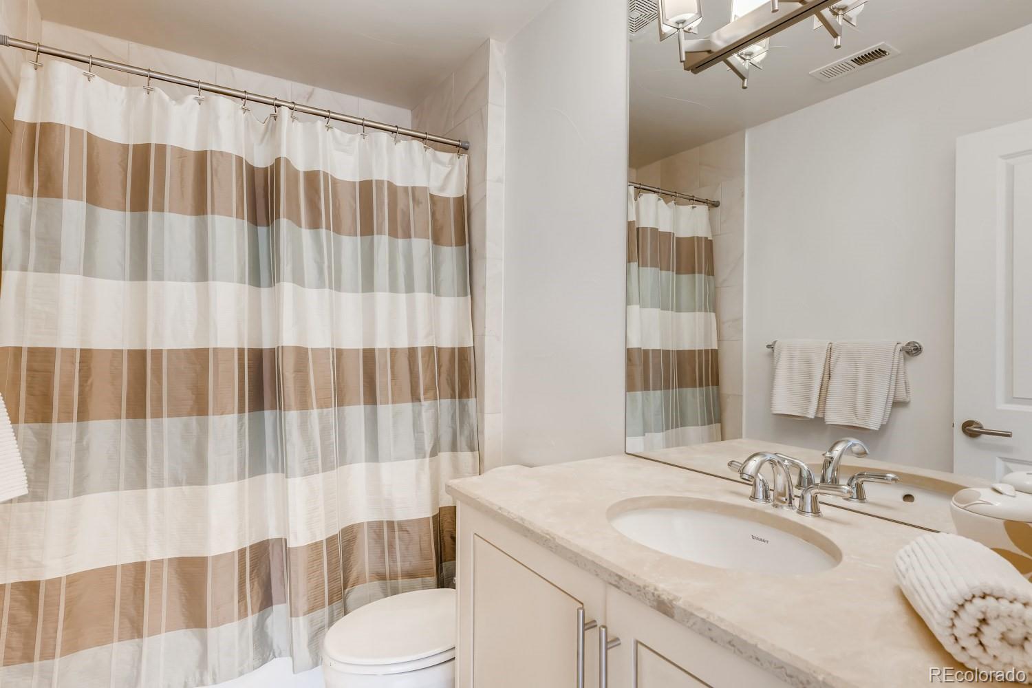 436 Jackson Street Denver, CO 80206 - Photo 27 of 40 a bathroom with a sink and a mirror