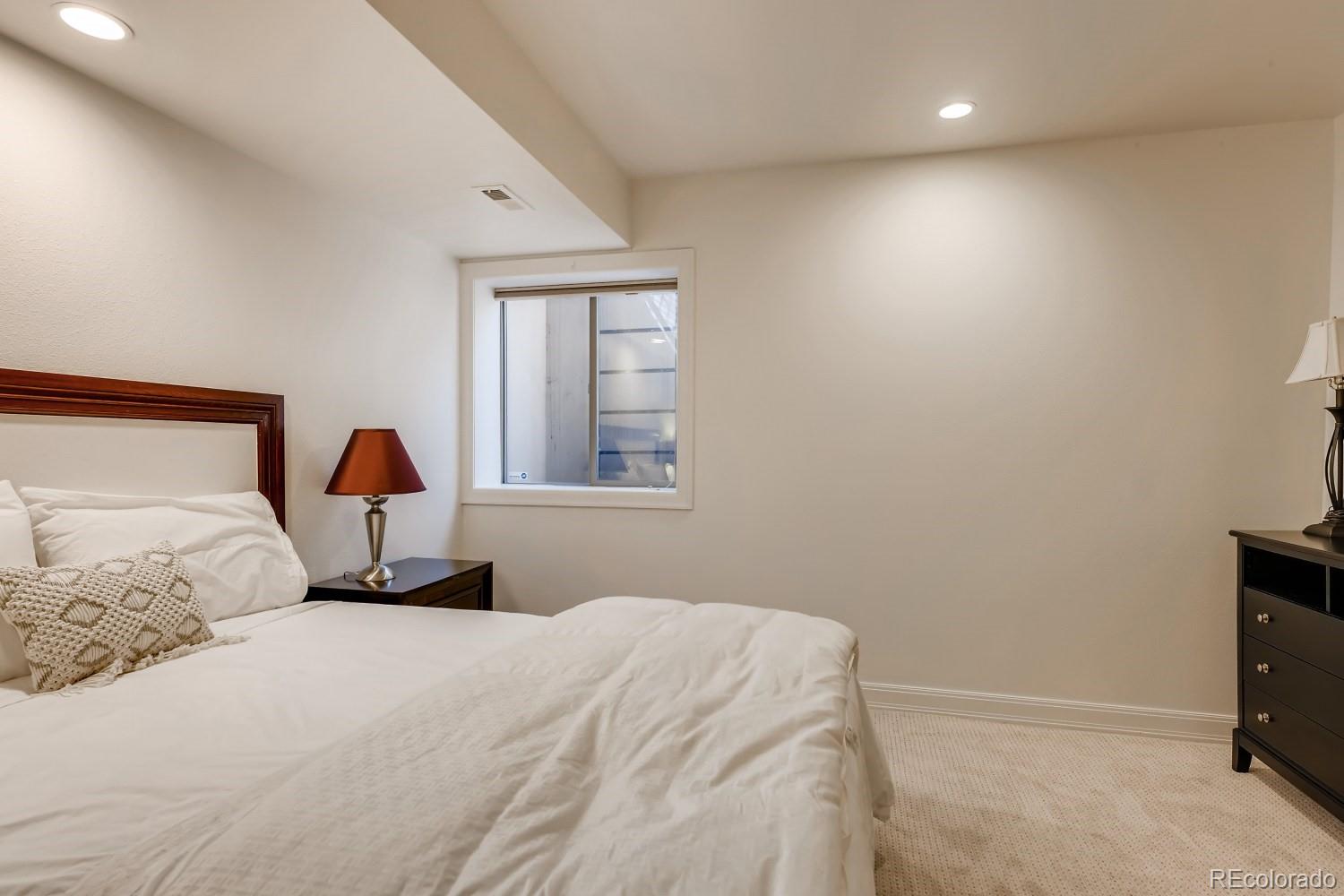 436 Jackson Street Denver, CO 80206 - Photo 32 of 40 a bedroom with a bed and a window