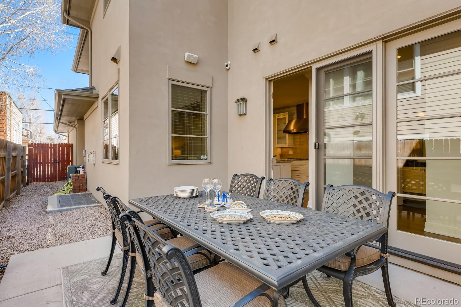 436 Jackson Street Denver, CO 80206 - Photo 36 of 40 a view of a dining table and chairs in the patio