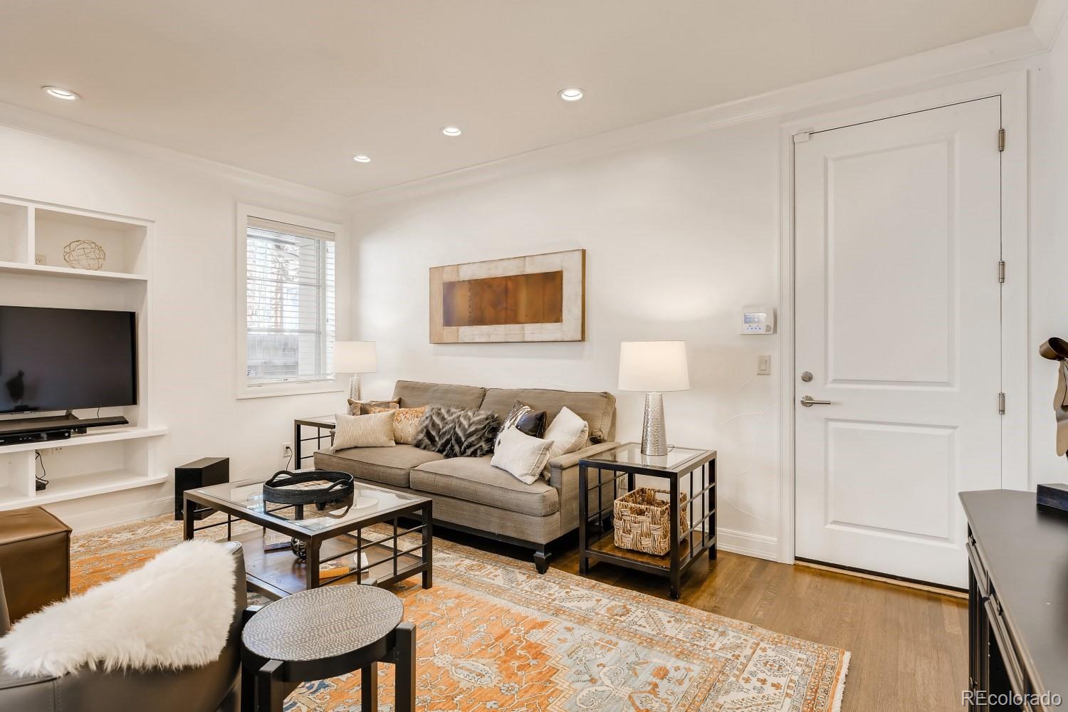 436 Jackson Street Denver, CO 80206 - Photo 8 of 40 a living room with furniture and a flat screen tv