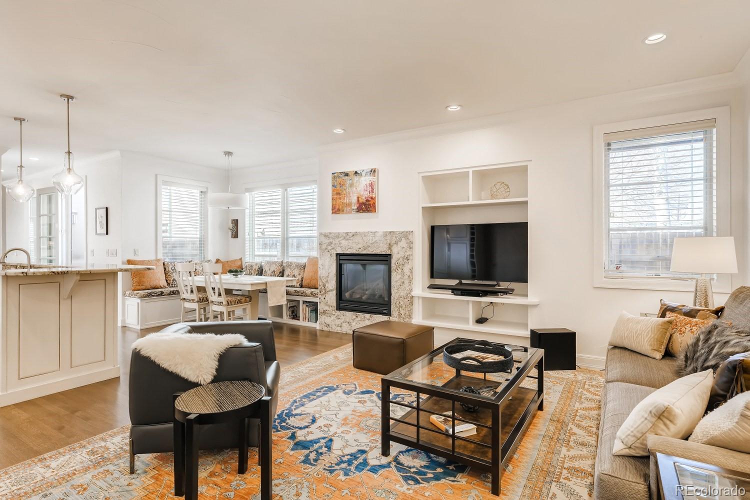 436 Jackson Street Denver, CO 80206 - Photo 9 of 40 a living room with furniture a flat screen tv and a fireplace