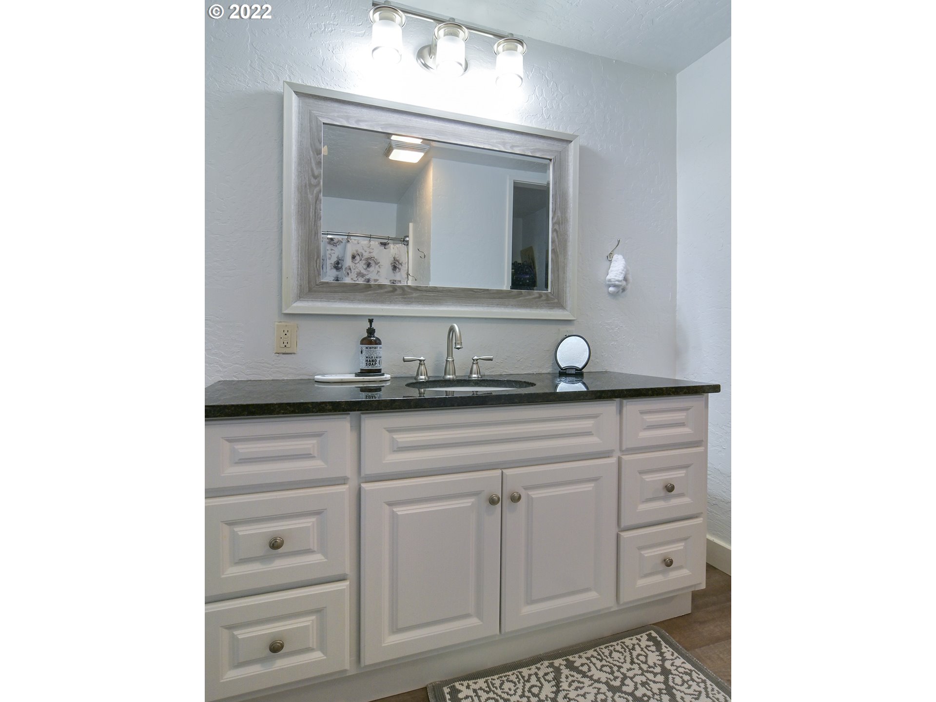 1704 H Street Springfield, OR 97477 - Photo 23 of 30 a bathroom with a sink and a mirror