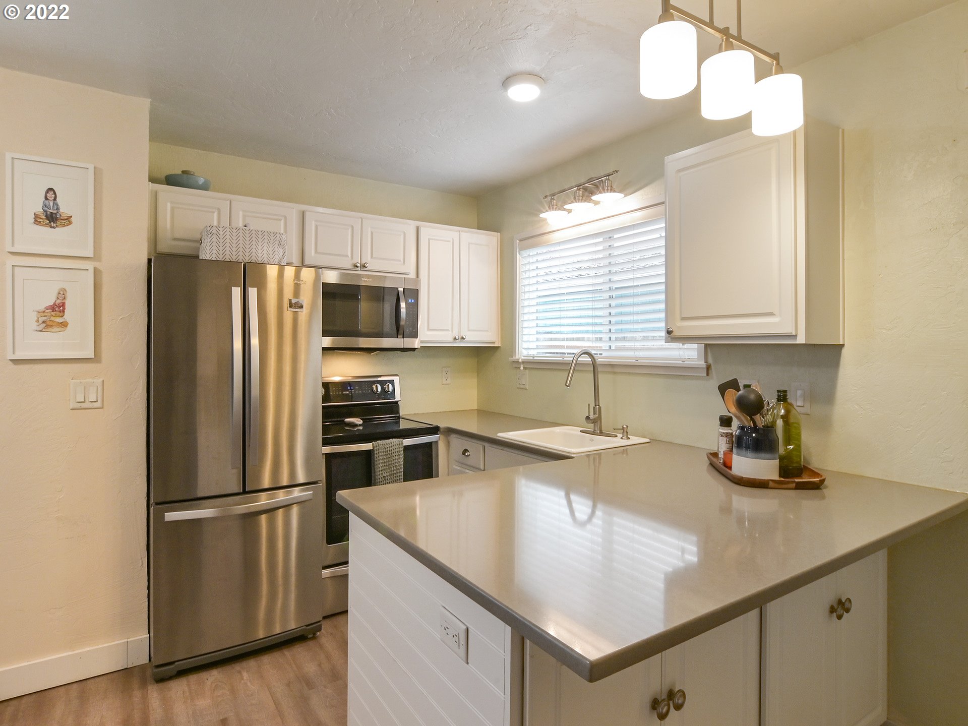 1704 H Street Springfield, OR 97477 - Photo 7 of 30 a kitchen with a refrigerator a sink a stove and cabinets