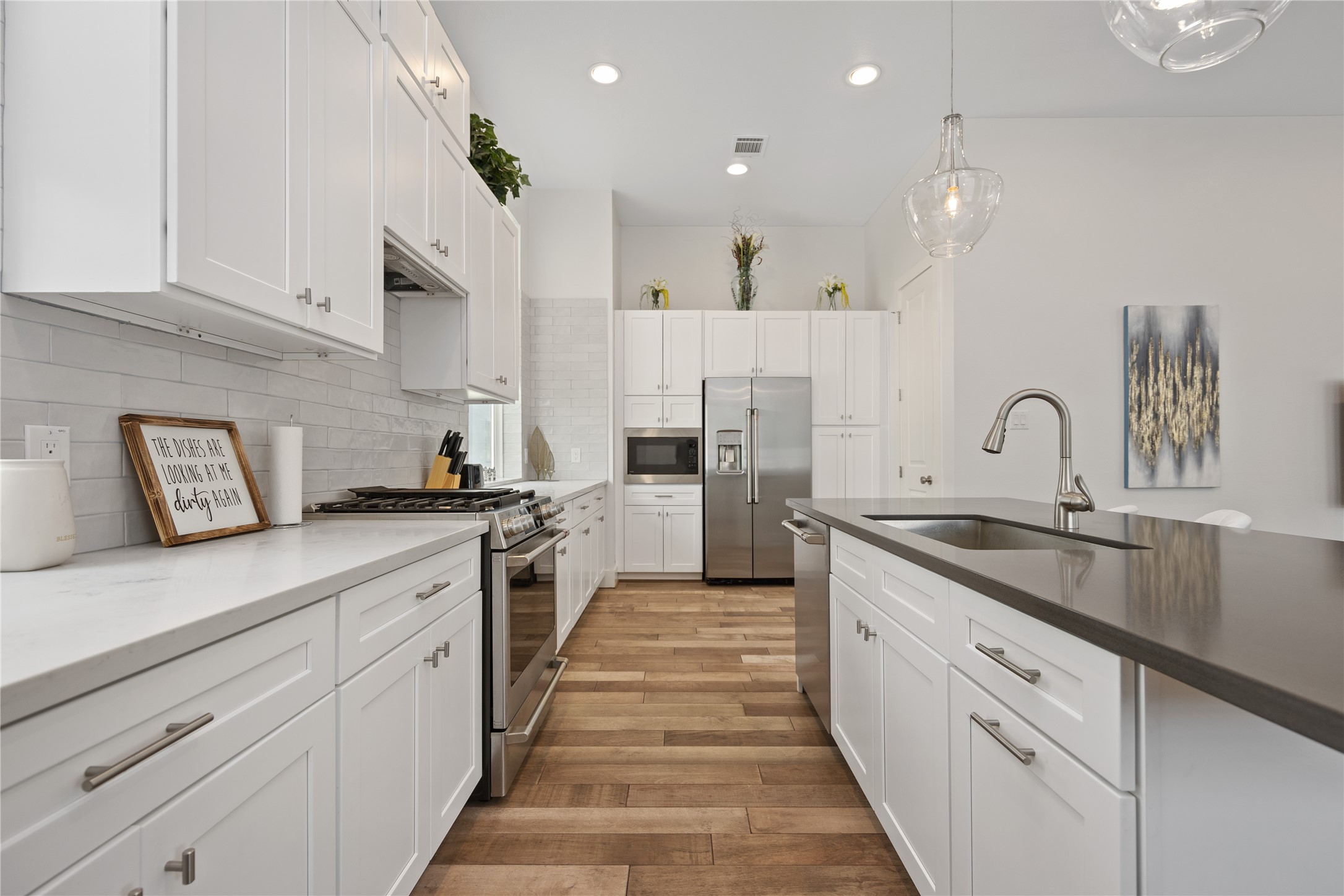 5914 Val Verde Street Houston, TX 77057 - Photo 8 of 25 a kitchen with white cabinets sink and stainless steel appliances
