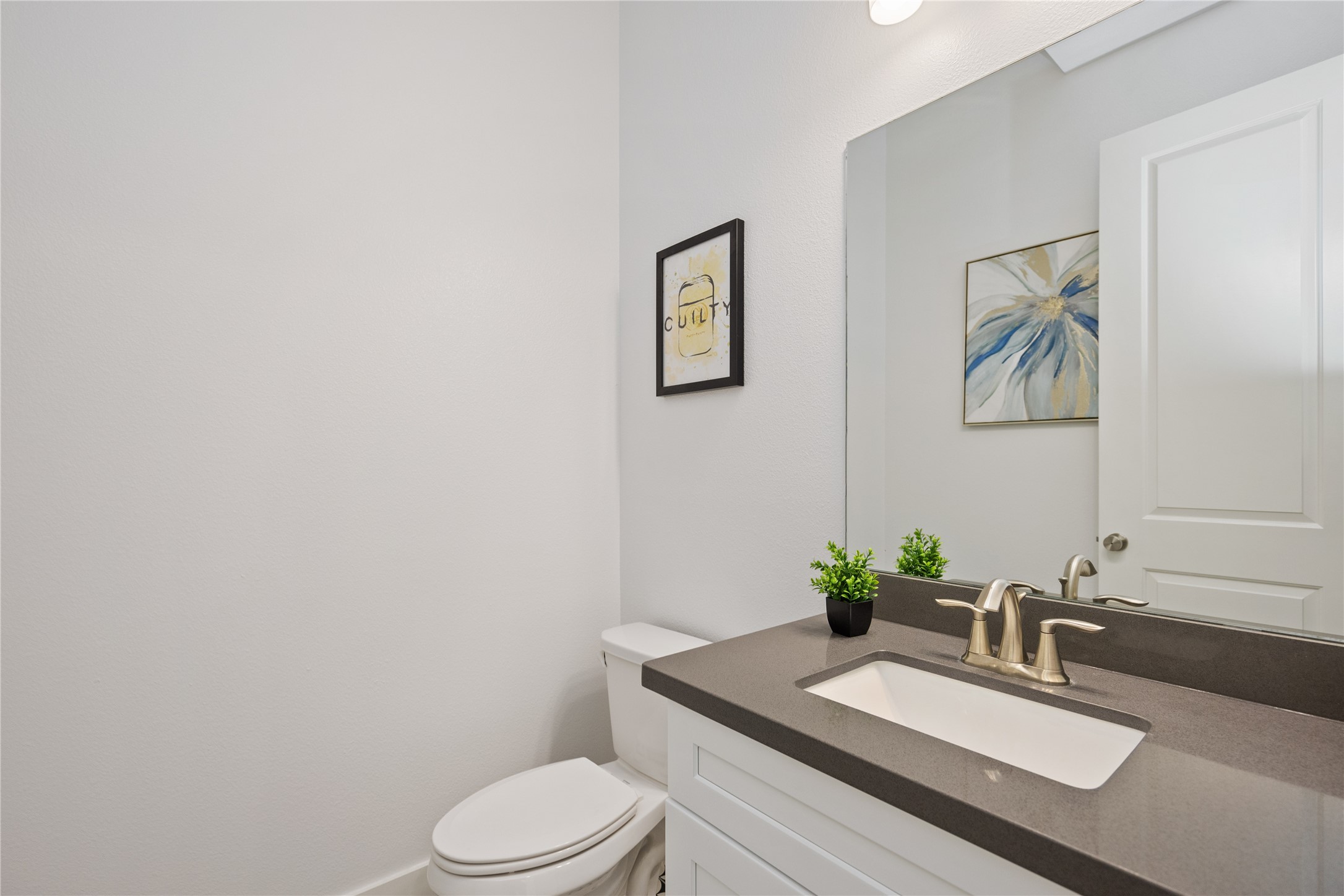 5914 Val Verde Street Houston, TX 77057 - Photo 10 of 25 a bathroom with a granite countertop toilet a sink and mirror