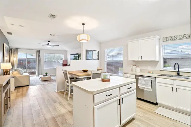 a view of a yard with a wooden fence