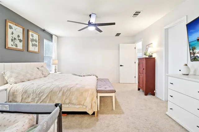 a bedroom with a bed and flat screen tv
