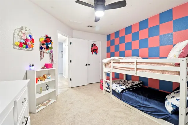 a bedroom with a bed and a white cabinets