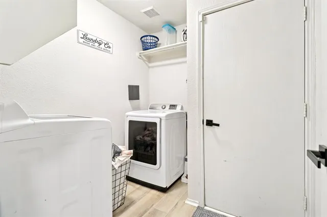 a bathroom with a sink a toilet and a shower curtain