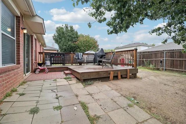 a backyard of a house with barbeque oven table and chairs