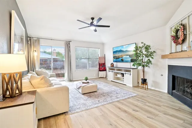 a living room with furniture a fireplace and a flat screen tv