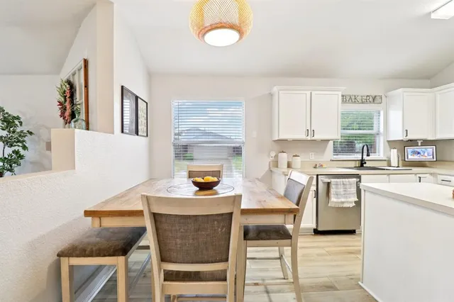a kitchen with a stove a sink and a refrigerator