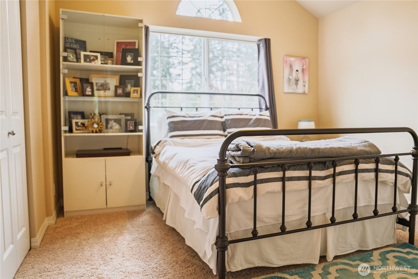 27661 McIntosh Loop Northeast Kingston, WA 98346 - Photo 22 of 34 a bed sitting in a bedroom next to a window