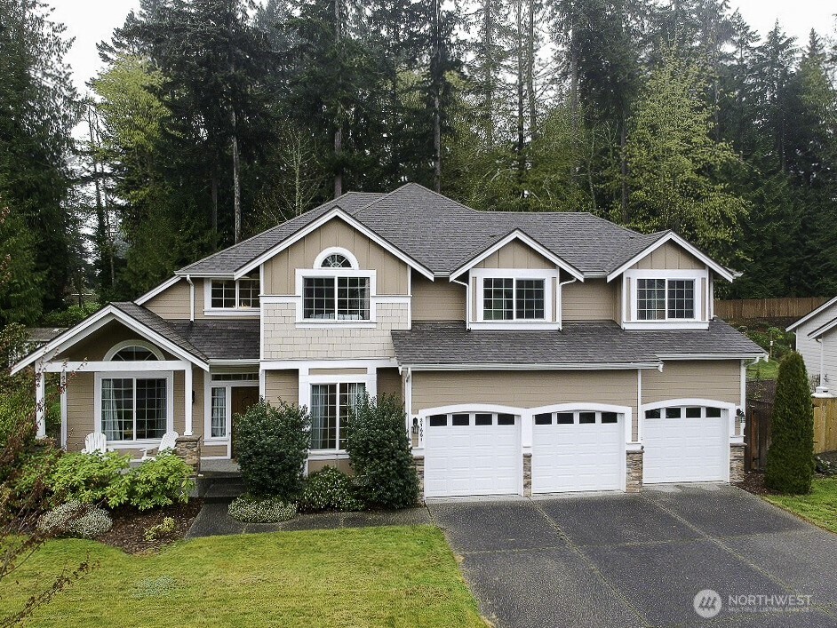 27661 McIntosh Loop Northeast Kingston, WA 98346 - Photo 28 of 34 a front view of a house with a yard and garage