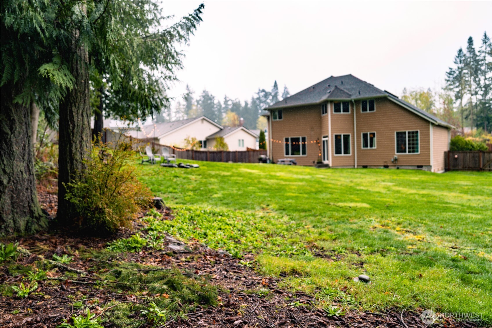 27661 McIntosh Loop Northeast Kingston, WA 98346 - Photo 31 of 34 a white house with a big yard and large trees