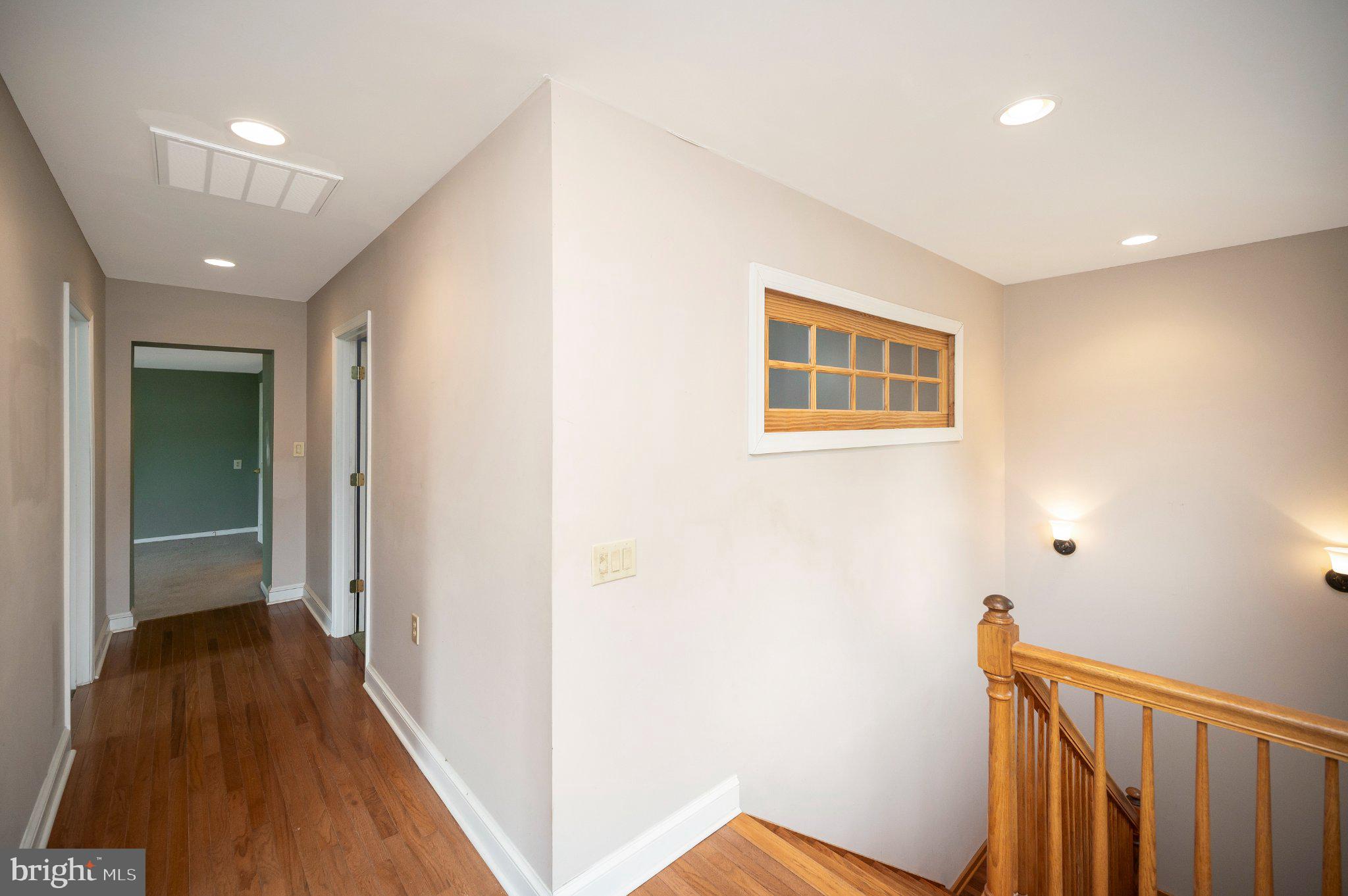 23202 Village Road Unionville, VA 22567 - Photo 30 of 58 a view of a hallway with wooden floor and staircase